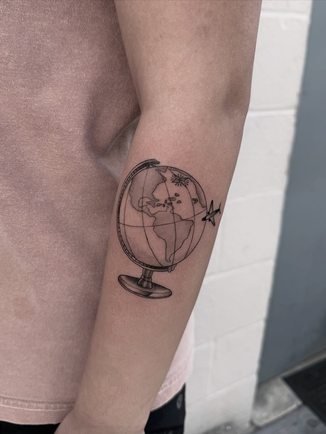 Unique globe tattoo showcasing artistic world map details Tattoo Design