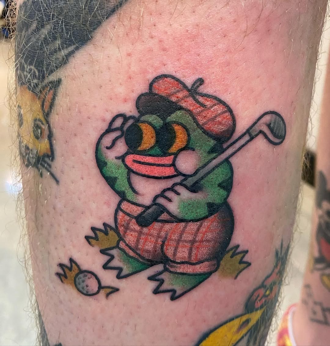 Playful frog golfer tattoo with whimsical charm Tattoo Design