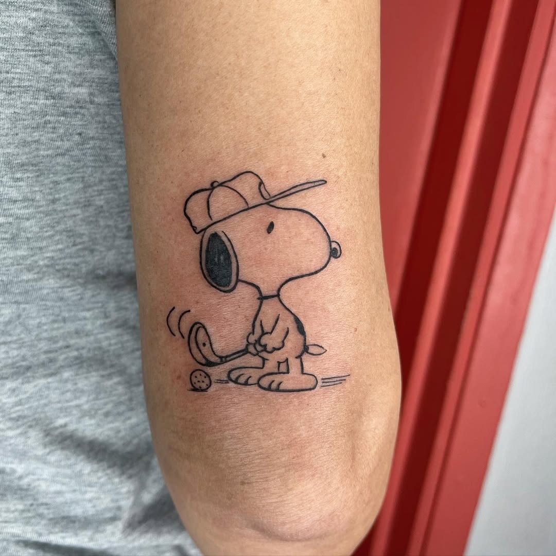 Playful Snoopy Golf Tattoo on Elbow Tattoo Design