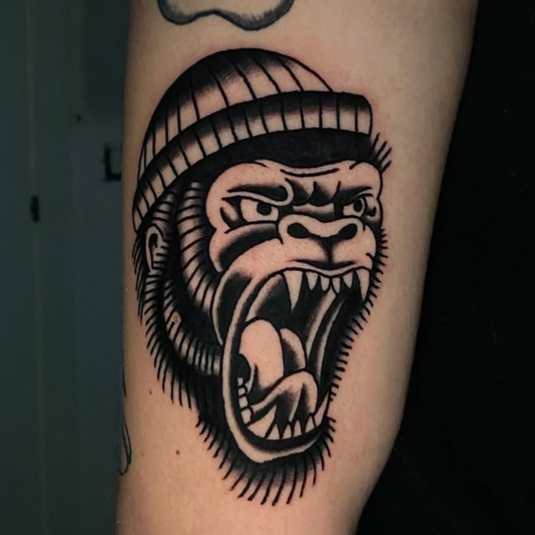 This striking gorilla tattoo features bold lines and intense expression.
