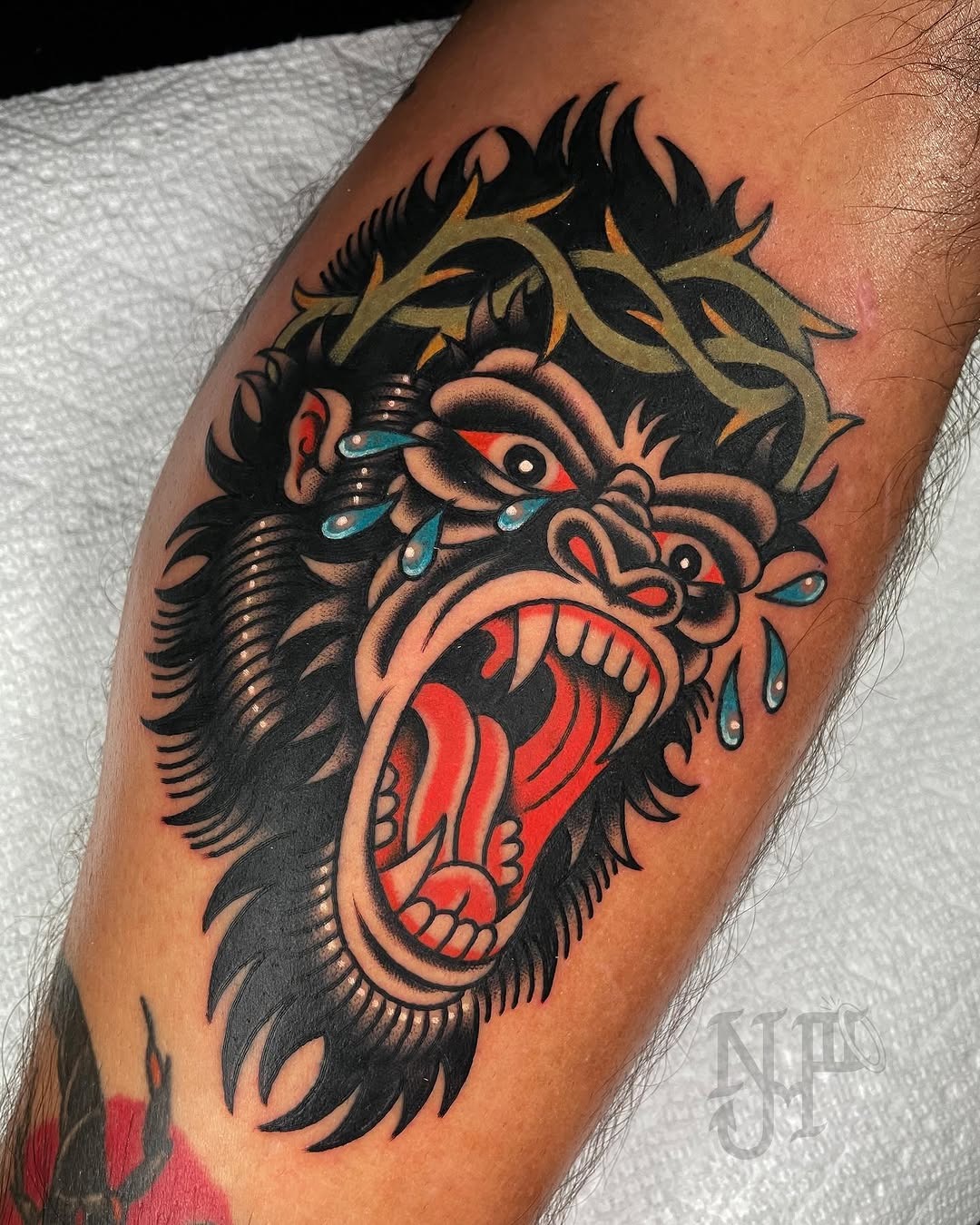 This striking gorilla tattoo showcases colors and intense emotion.