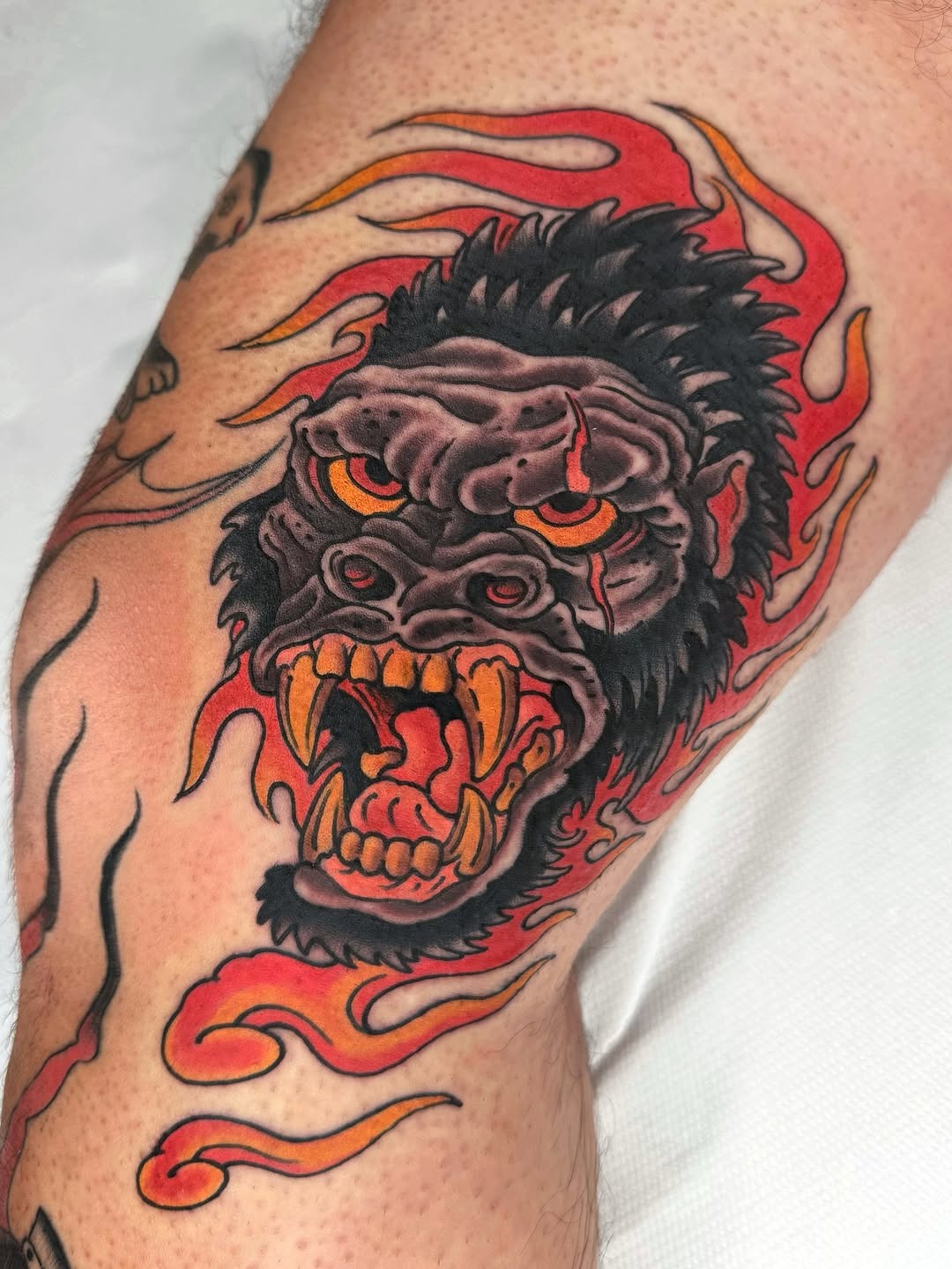 This gorilla tattoo showcases fierce detailing with bold, colors.