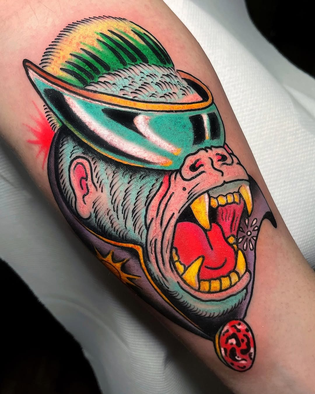 This striking gorilla tattoo features bold colors and a distinct design, making it a true statement piece.
