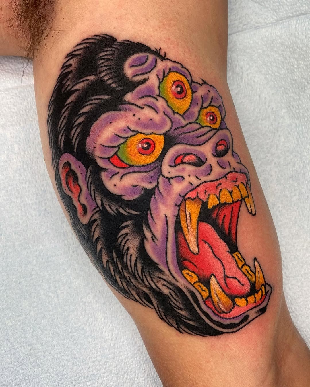 This striking gorilla tattoo features colors and an expressive face.