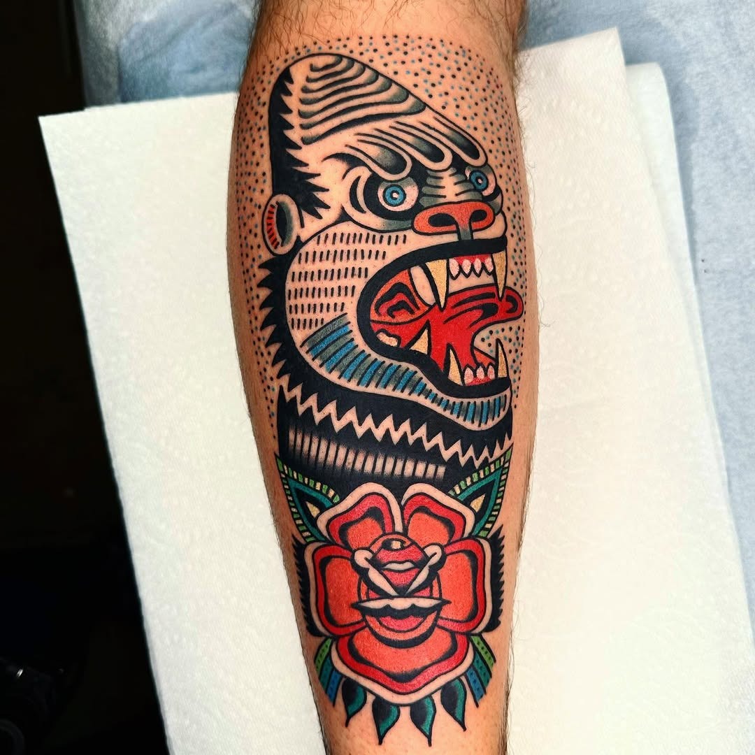 This tattoo features a striking gorilla design, bursting with color and intricate details.