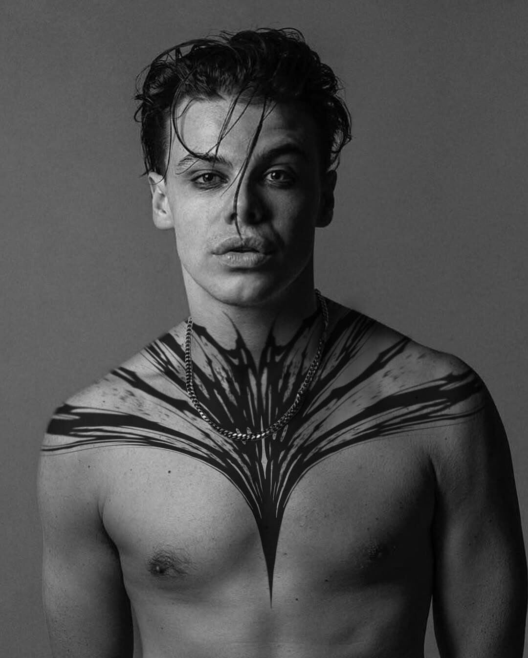 Striking black ink chest tattoo for men Tattoo Design