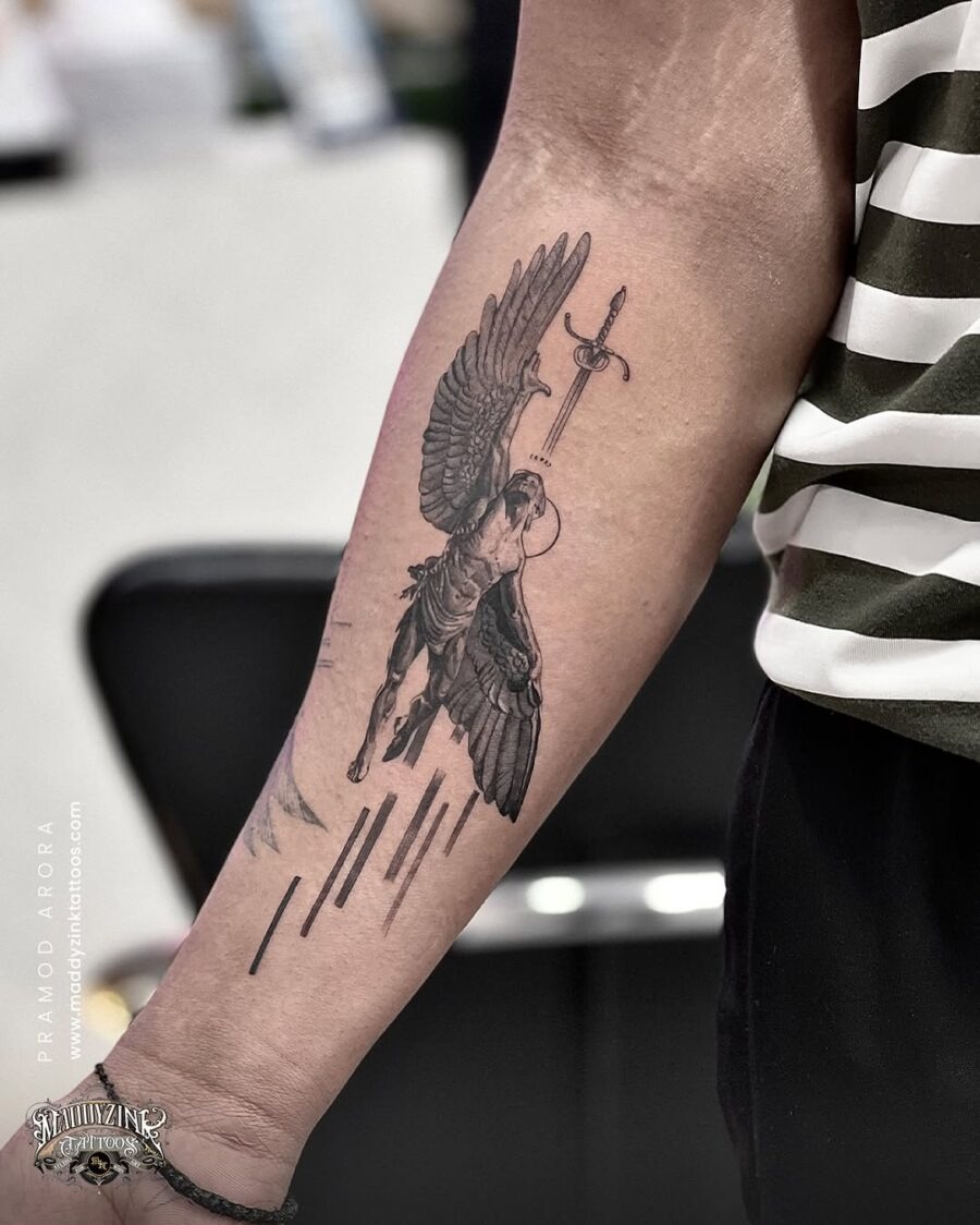 This tattoo showcases the striking imagery of a Greek god, possibly Michael, with majestic wings and a sword.