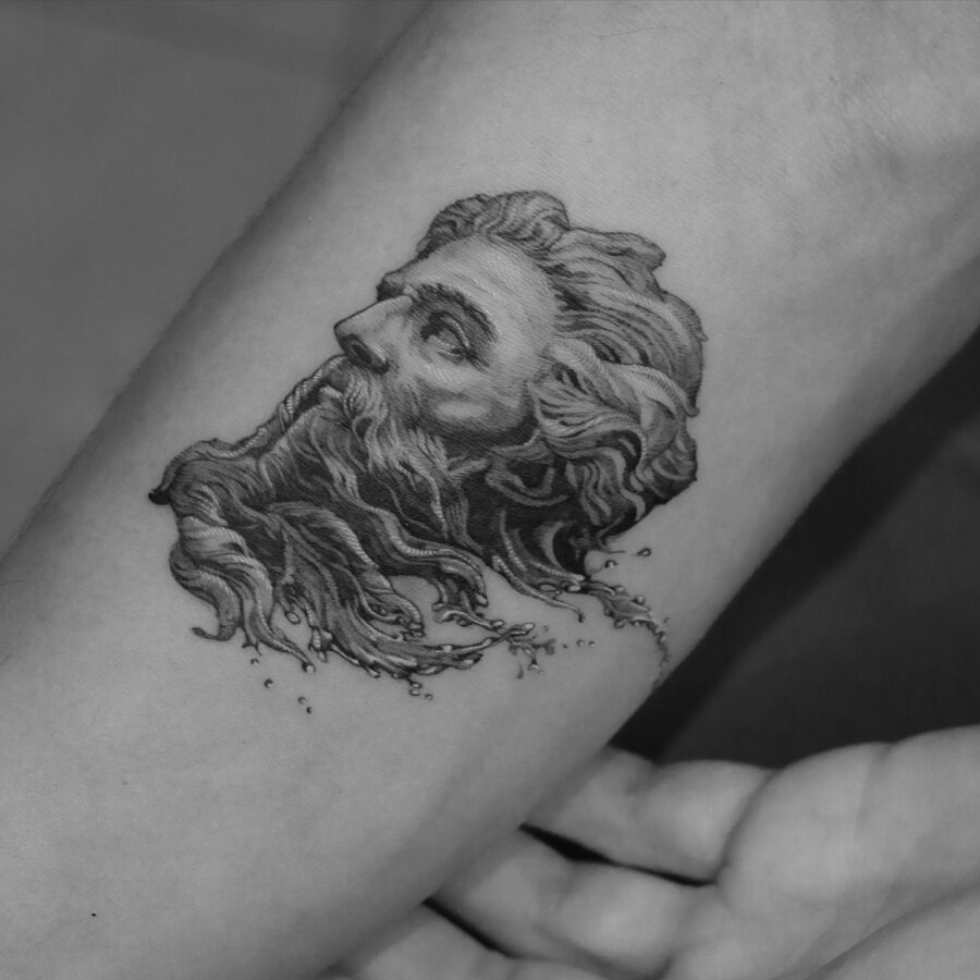 This tattoo depicts Poseidon, the Greek god of the sea, captured in a stunning black and grey design.