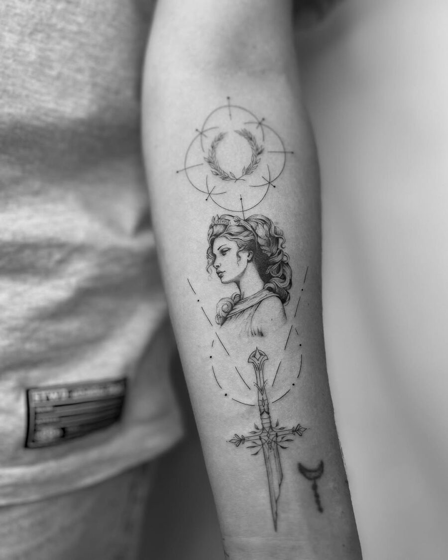 This tattoo features a striking portrait of a Greek goddess, elegantly presenting her profile.