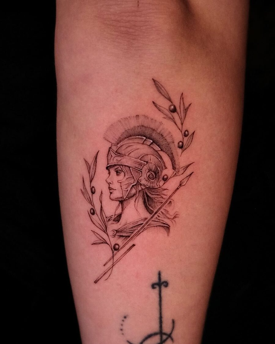 This tattoo features a beautifully detailed representation of Athena, the Greek goddess of wisdom and war.