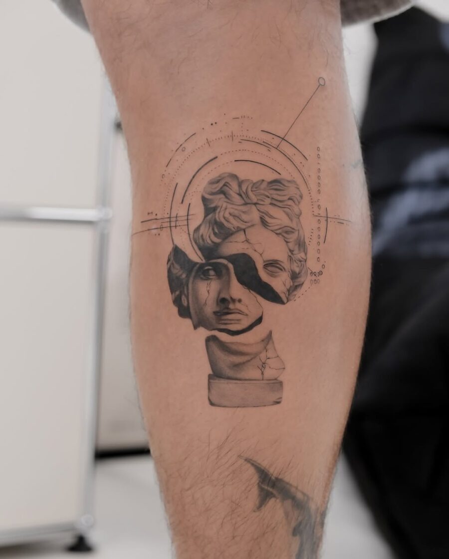 This tattoo combines classical Greek sculpture with modern design elements.