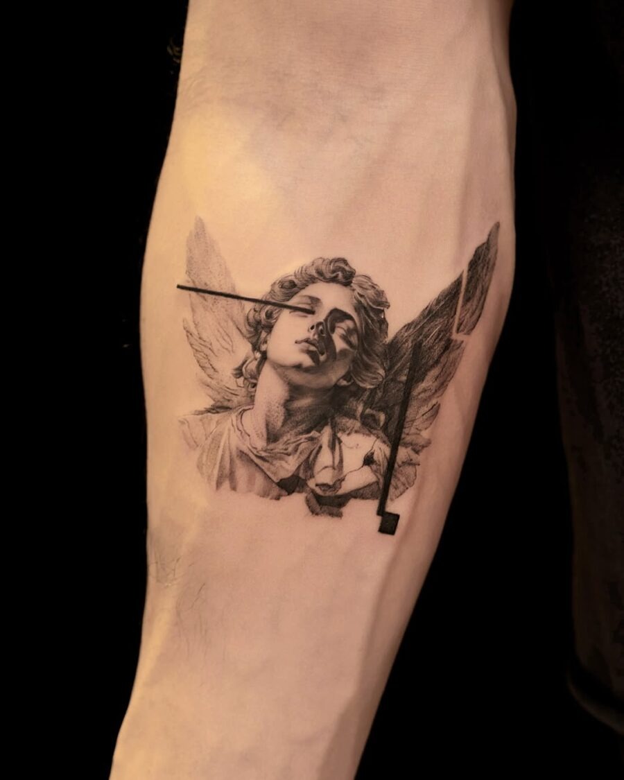 This tattoo features an intricate depiction of an angelic figure, blending realism with artistic flair.