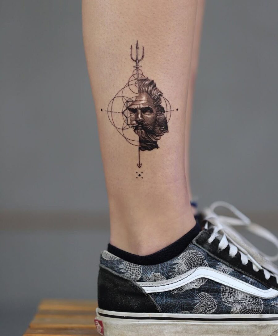 This tattoo features an elaborately designed portrait of Zeus, complete with his iconic beard and lightning bolt.