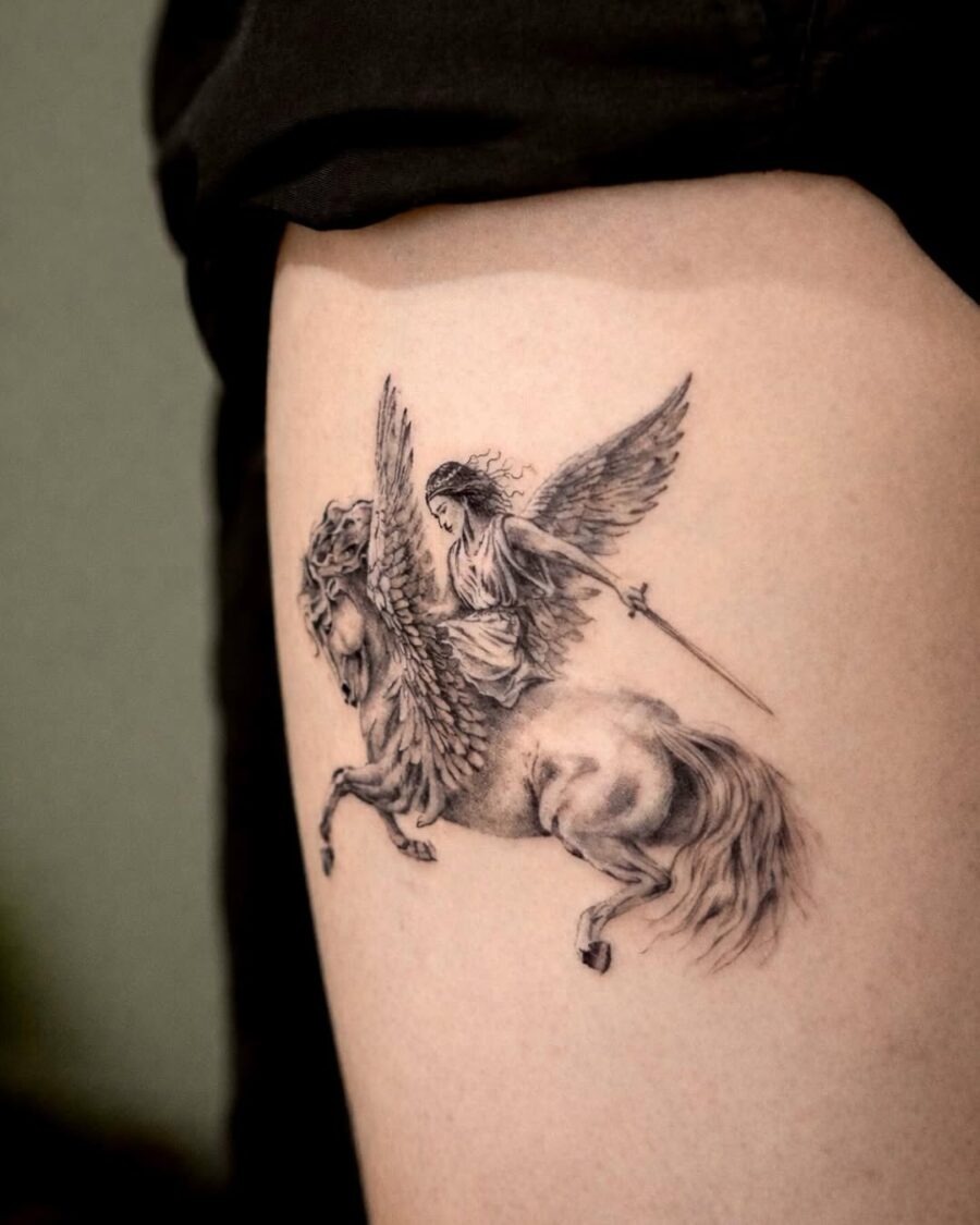 This intricate tattoo features a winged goddess elegantly mounted on a powerful horse.
