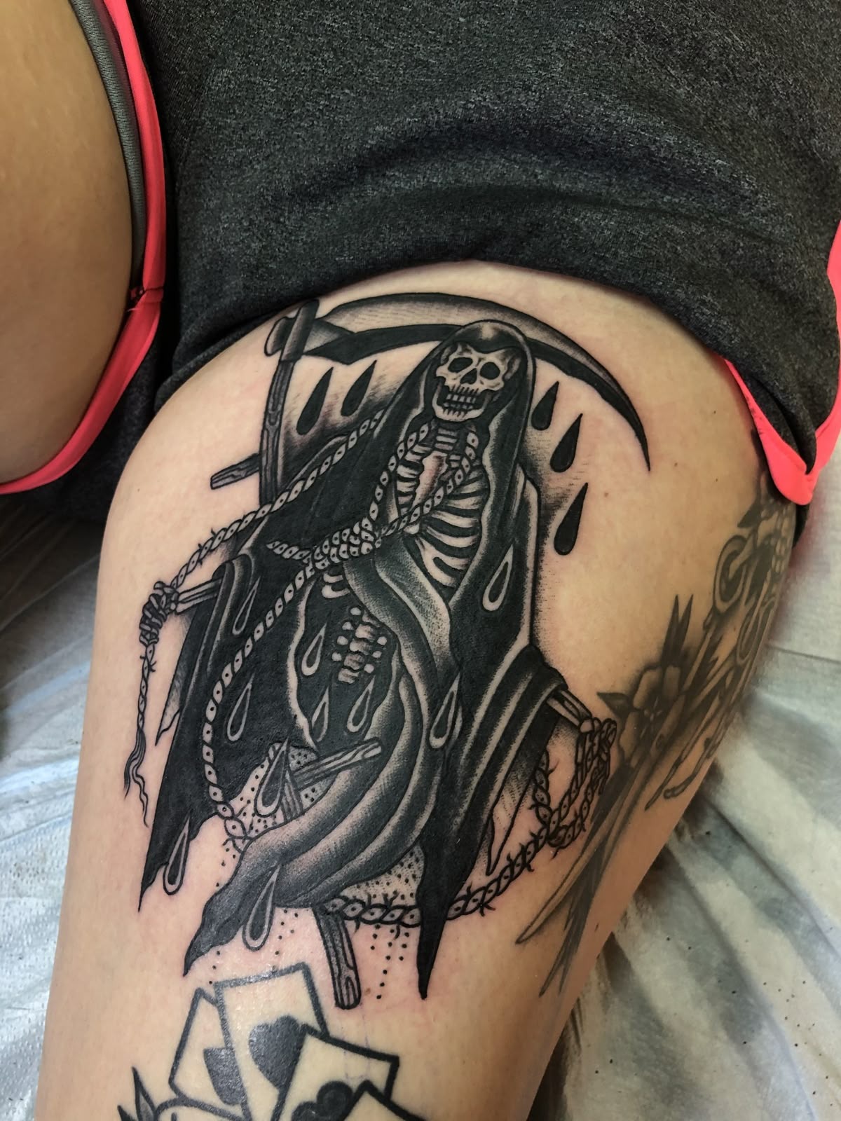 Beaded Reaper With Bold Thigh Placement, a tattoo design rendered in bold.