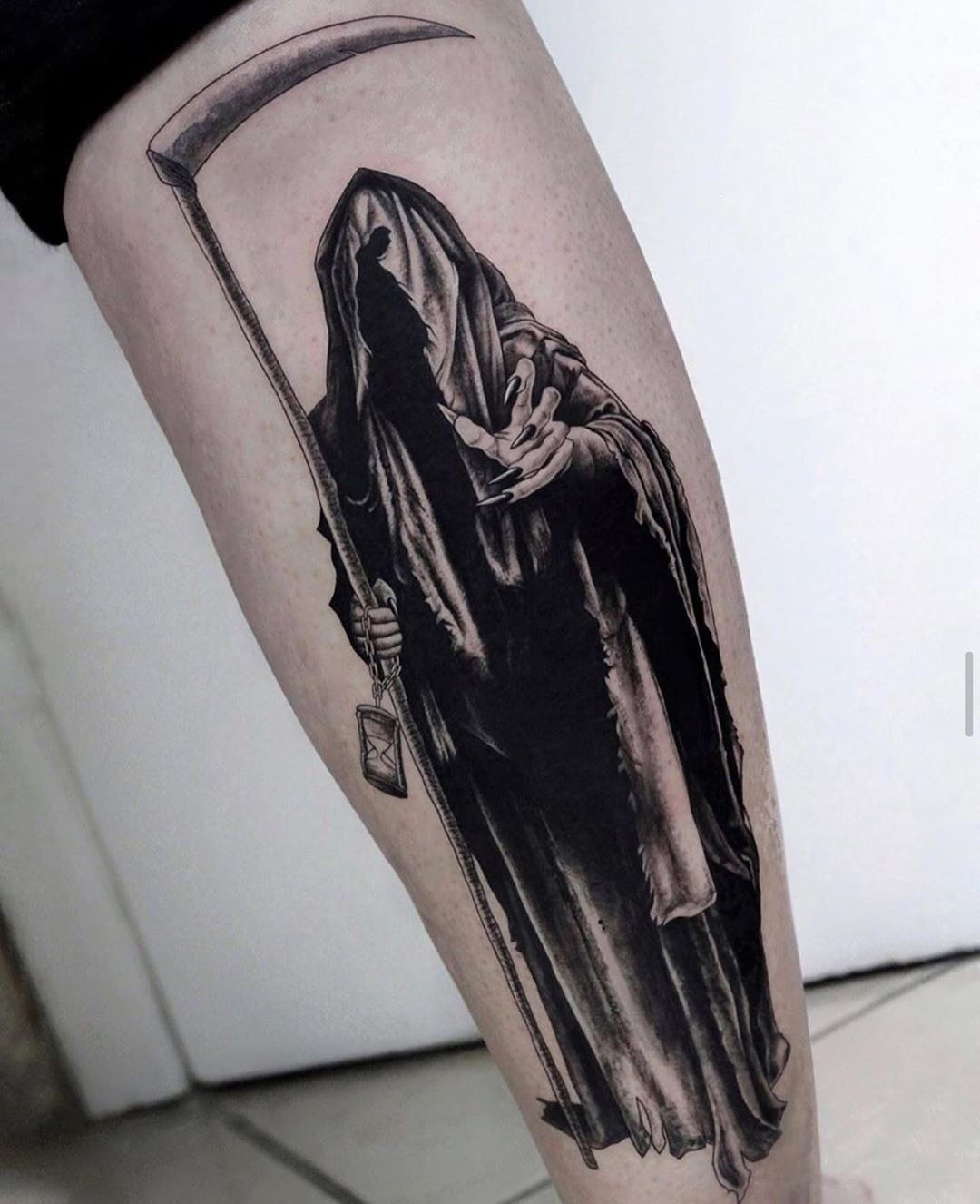 Full Figure Reaper With Hourglass Detail, a tattoo design rendered in bold for the hand.