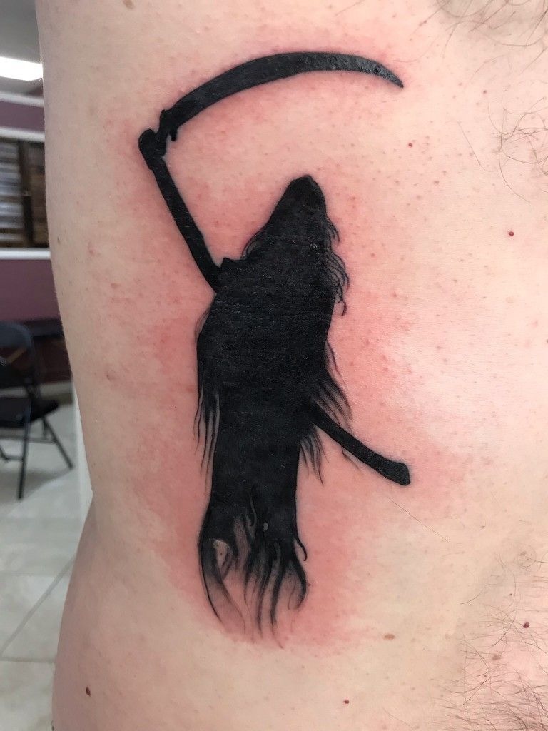 Minimal Black Silhouette Reaper, a tattoo design rendered in clean detailed linework.