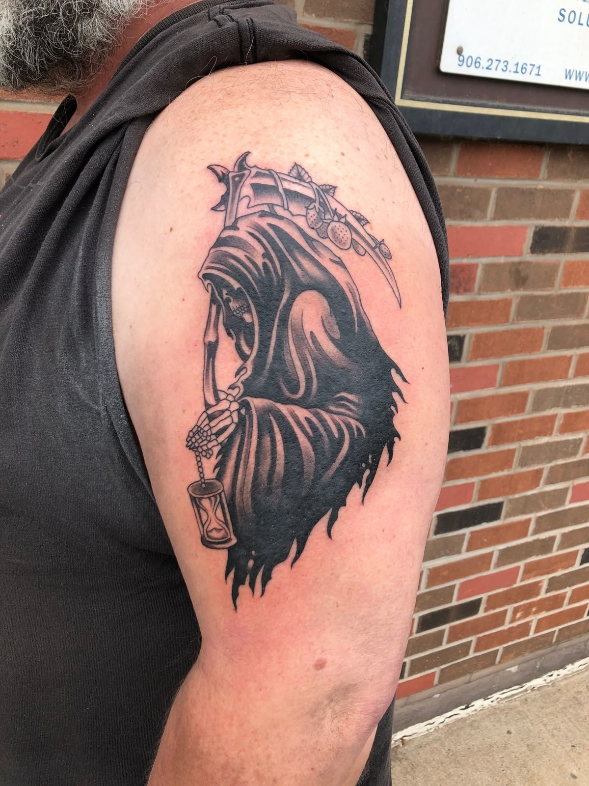 Reaper With Hourglass and Sharp Graphic Shape, a tattoo design rendered in clean detailed linework for the hand.