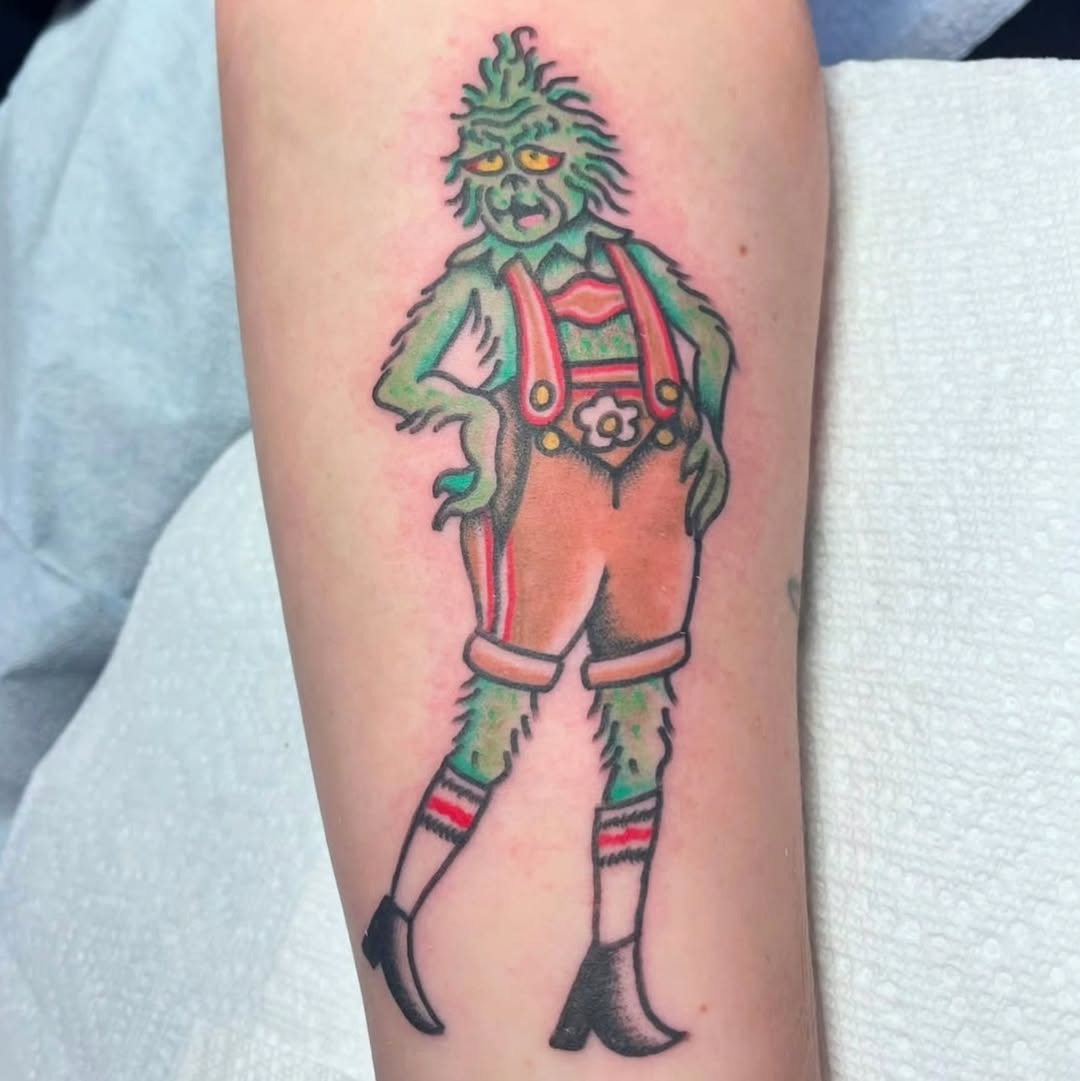 Stylized Grinch Tattoo with Fashionable Flair Tattoo Design