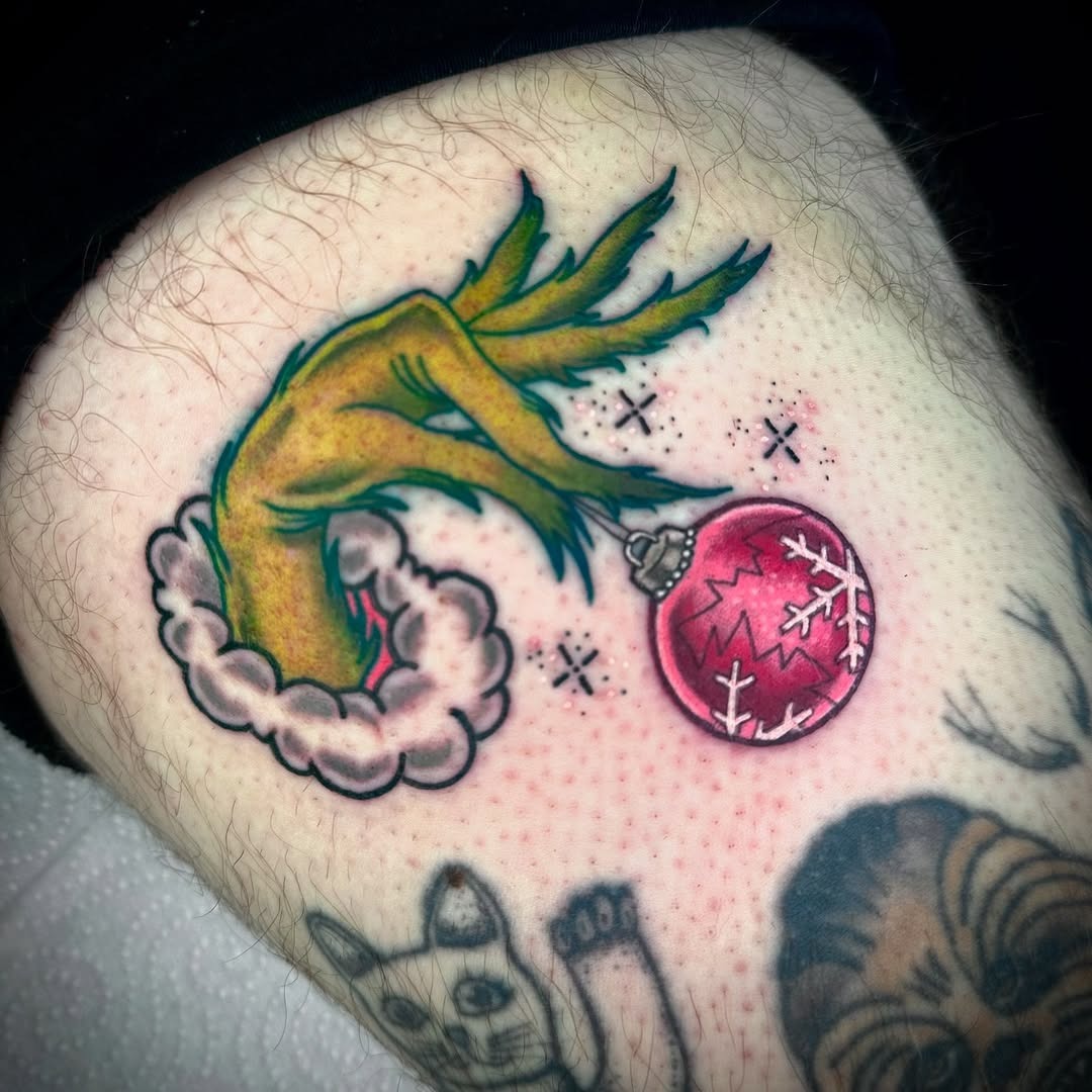 Unique Grinch hand tattoo with Christmas ornament Tattoo Design