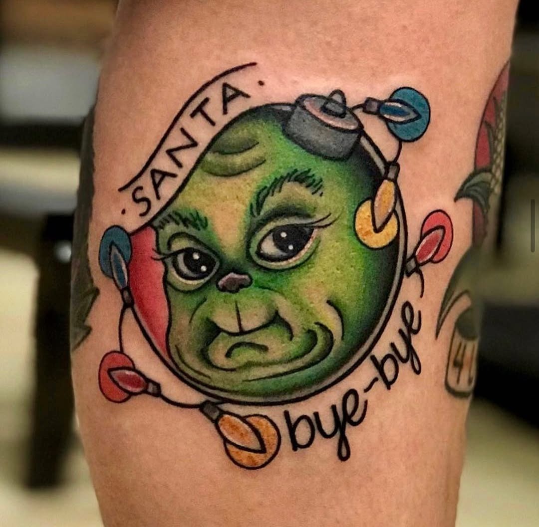 Whimsical Grinch Design with Holiday Cheer Tattoo Design