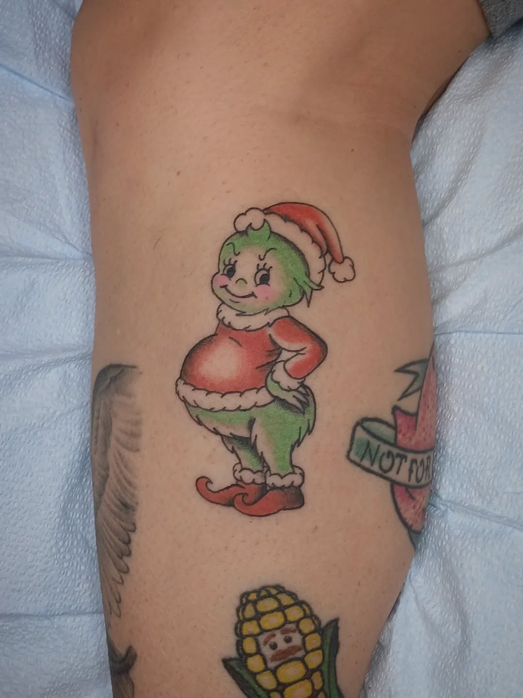 Whimsical Grinch Tattoo for Holiday Spirit Tattoo Design