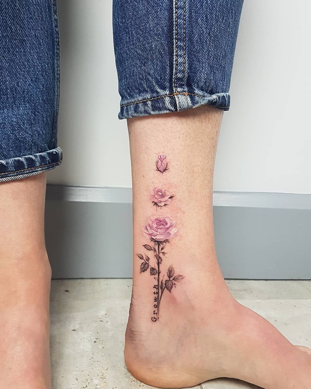 Elegant floral growth tattoo on the ankle Tattoo Design