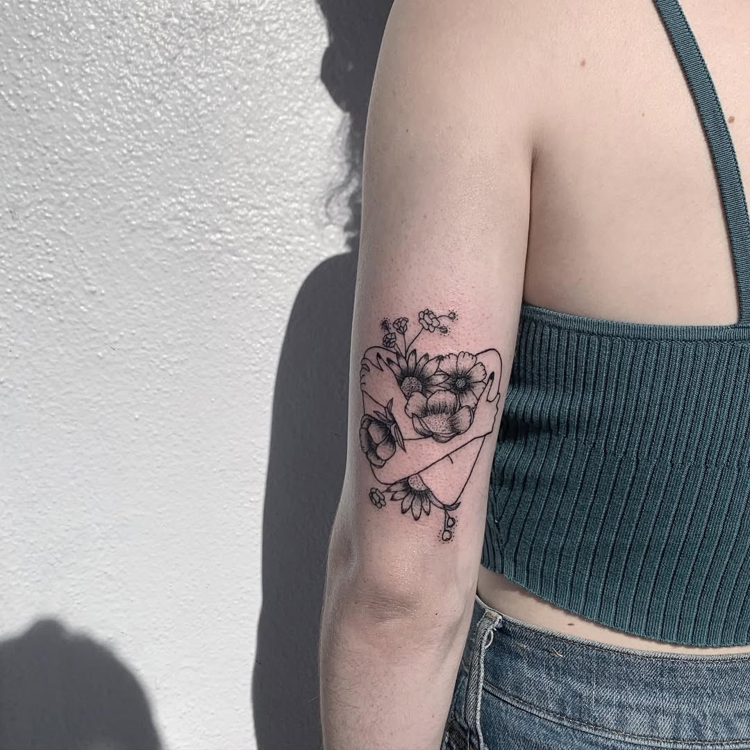 Elegant floral tattoo on a woman’s arm Tattoo Design