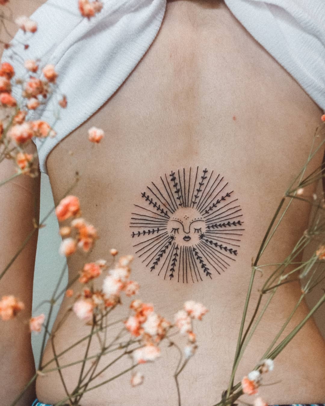 Radiant sunburst tattoo symbolizing personal growth Tattoo Design