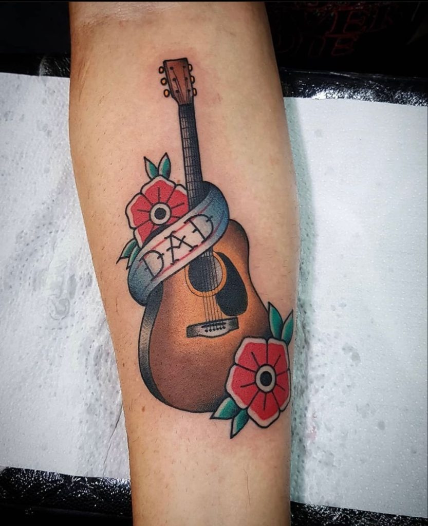 Black Electric Guitar With Floral Accents Tattoo Design