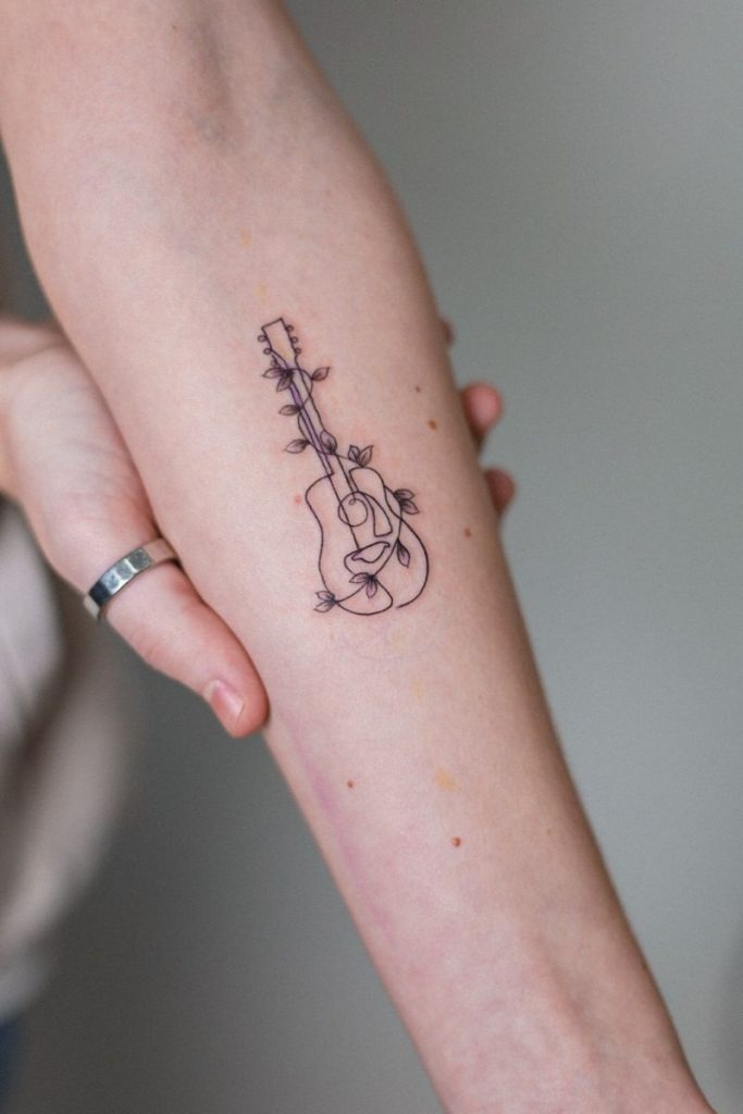 Minimalist Acoustic Guitar With Leaves Tattoo Design