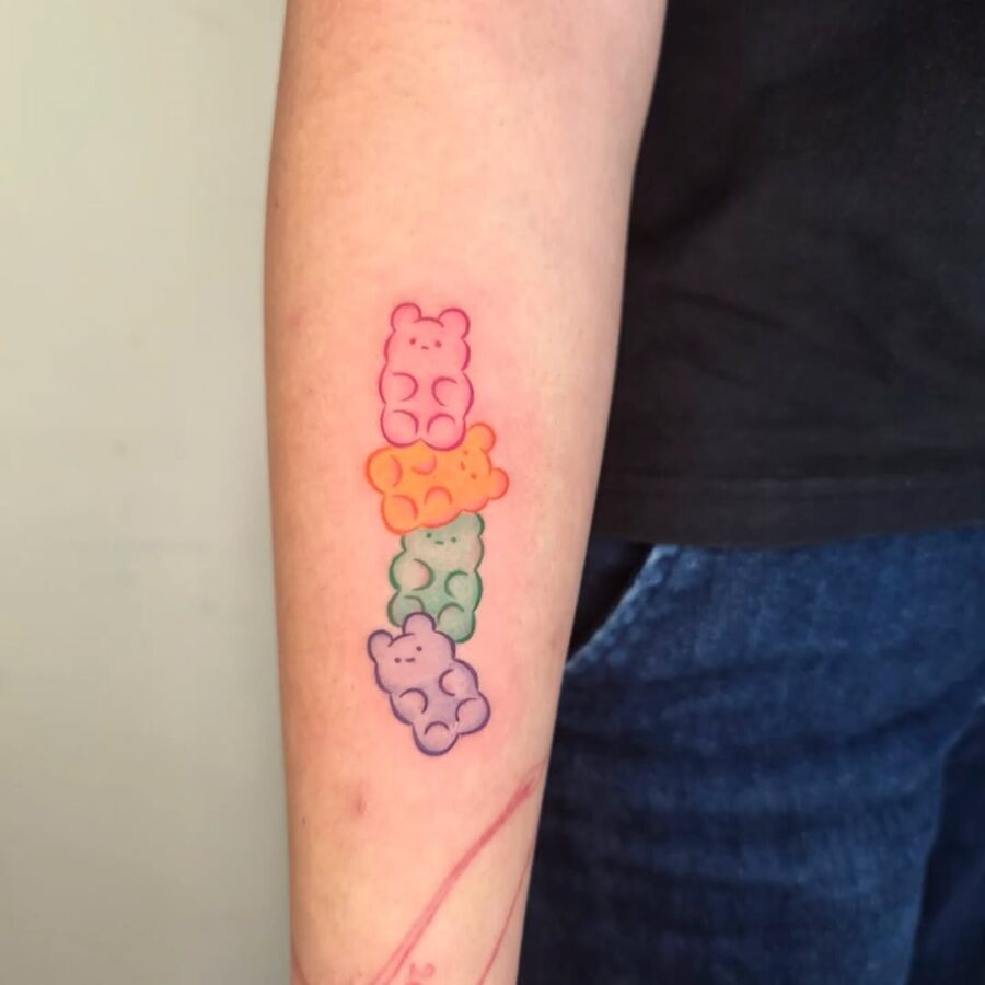 Colorful gummy bears adorned on forearm. Tattoo Design