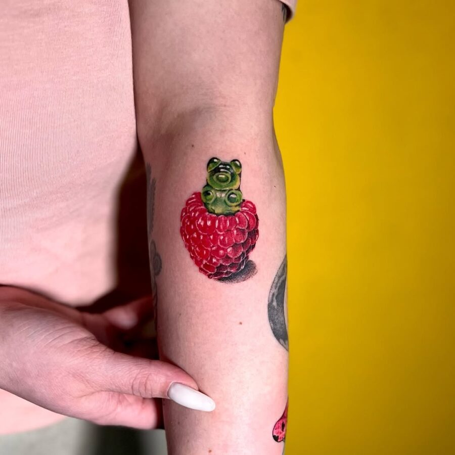Whimsical gummy bear atop a berry tattoo Tattoo Design