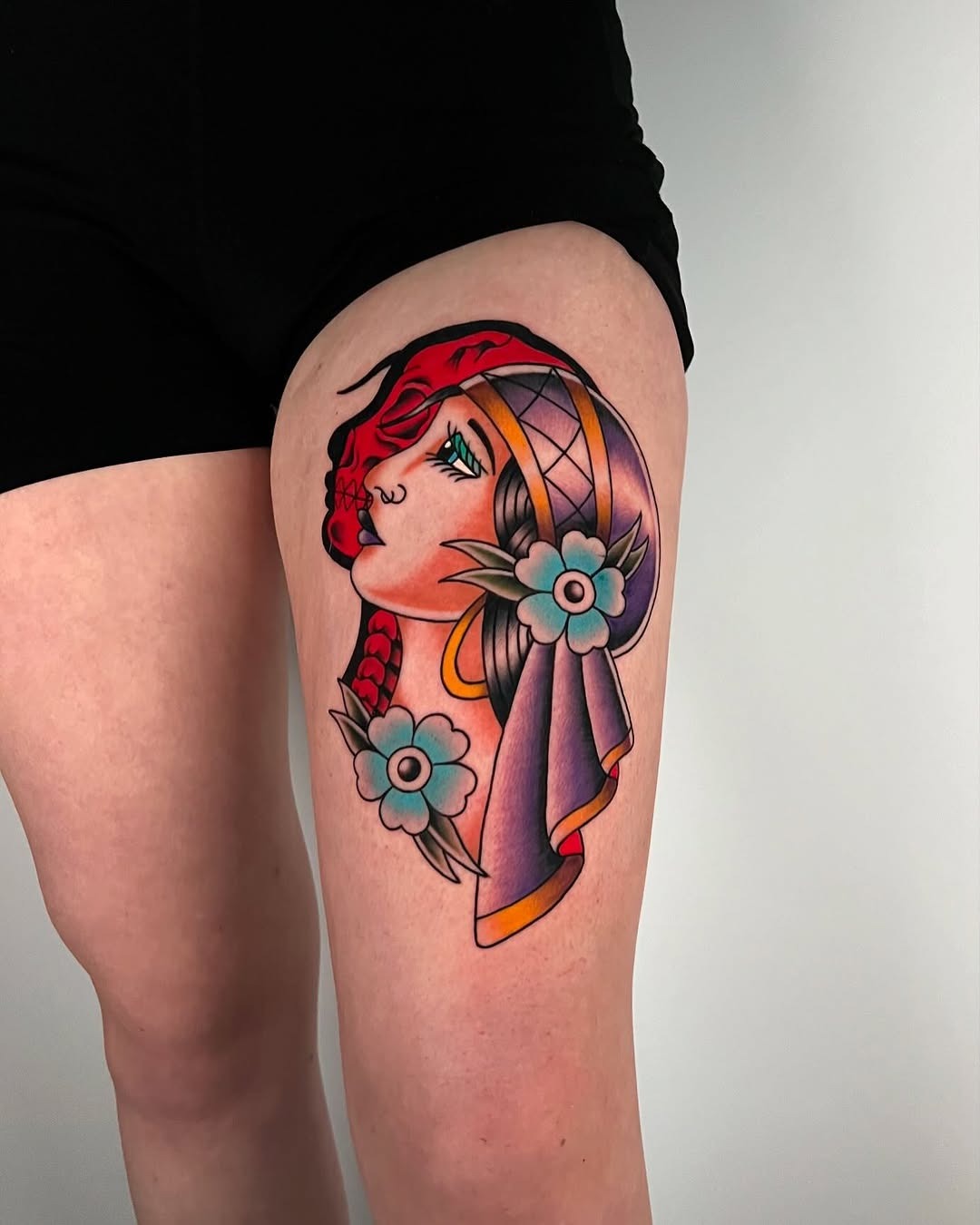 Vibrant Gypsy-Inspired Tattoo with Floral Elements Tattoo Design