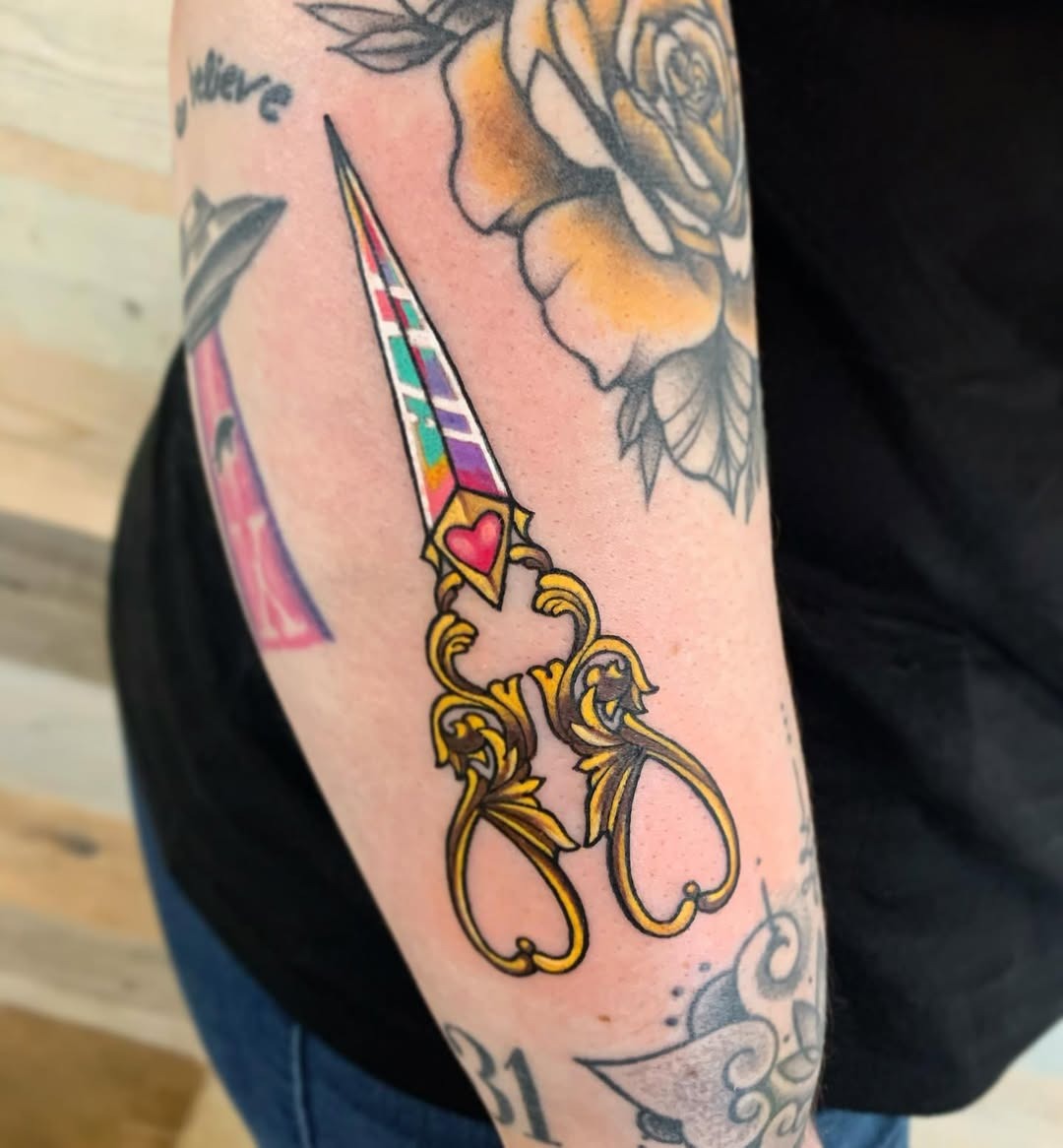 Colorful scissors tattoo celebrating hairstyling artistry Tattoo Design