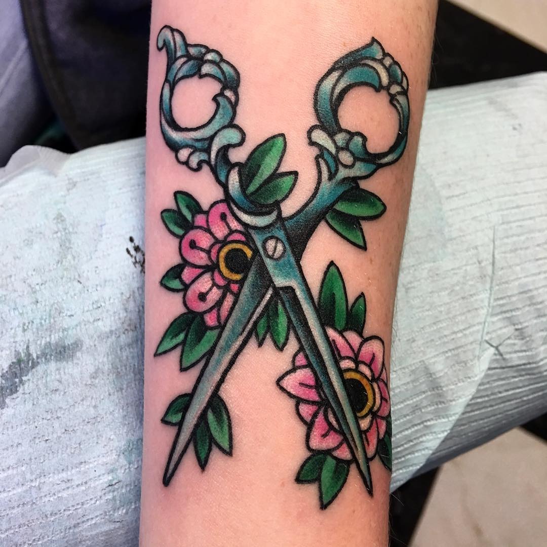 Creatively designed tattoo featuring scissors and flowers Tattoo Design