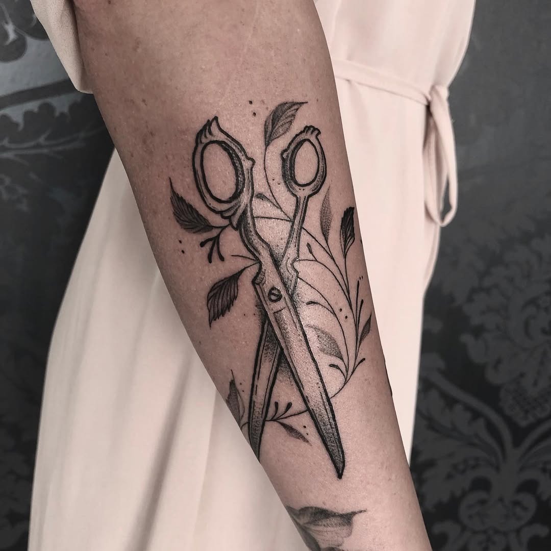 Elegant scissors tattoo with floral accents Tattoo Design