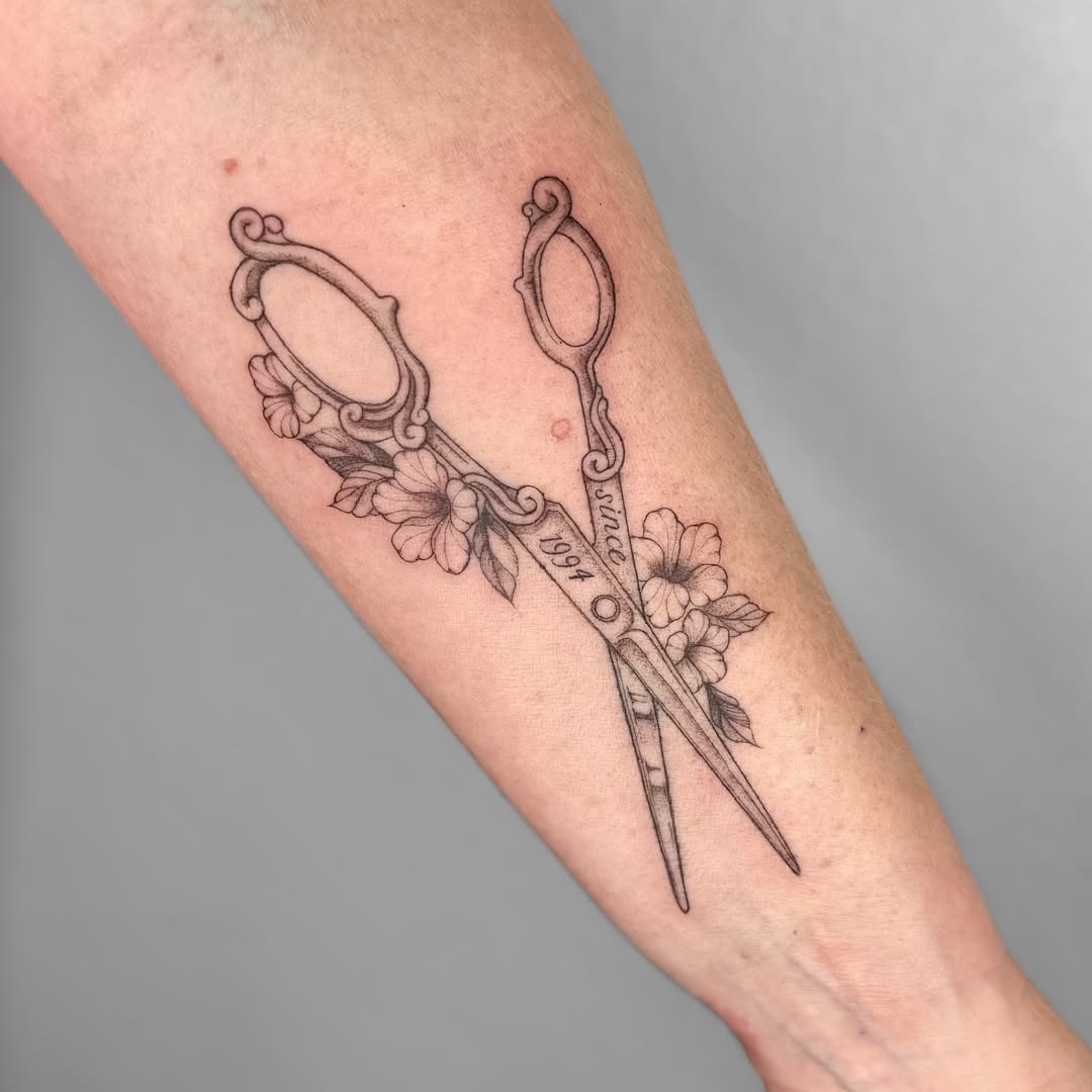 Intricate Scissors Tattoo with Floral Accents Tattoo Design