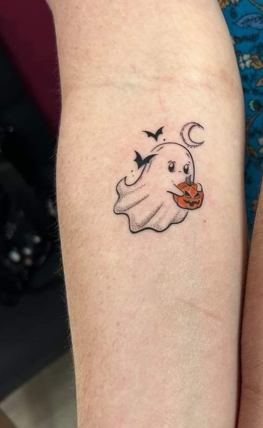Cute Ghost with Pumpkin Candy, a tattoo design rendered in clean detailed linework.