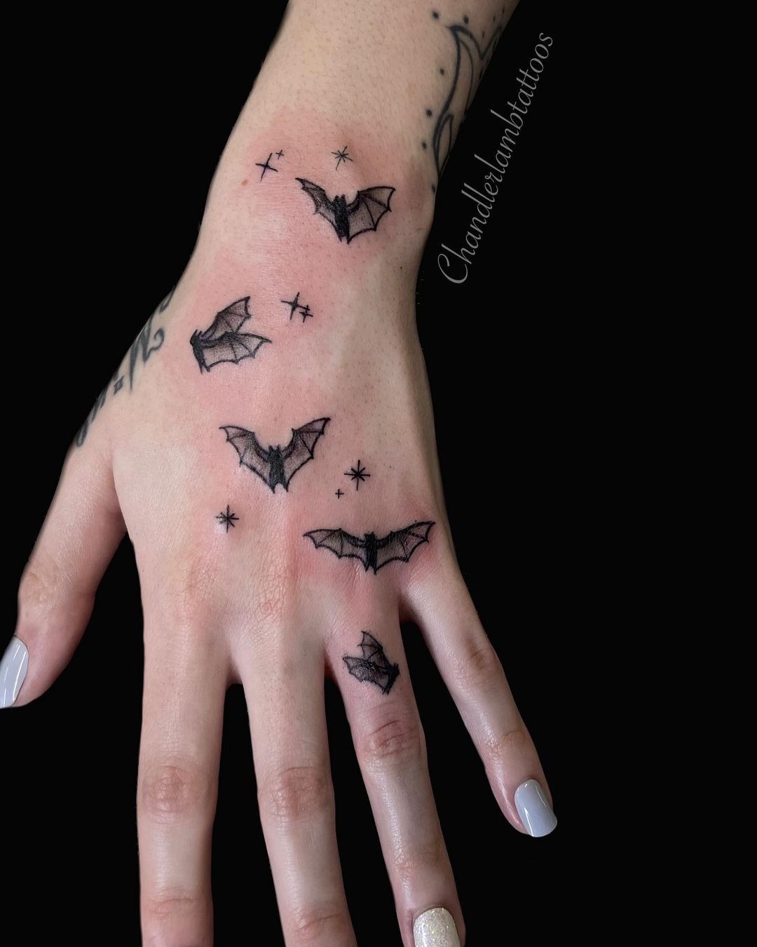 Mini Bats and Stars on Hand, a tattoo design rendered in clean detailed linework.