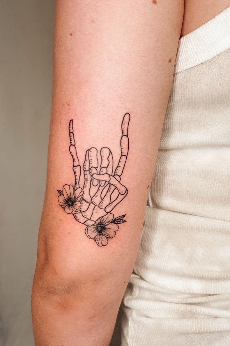 Skeleton Rock Hand with Florals, a tattoo design rendered in clean detailed linework.
