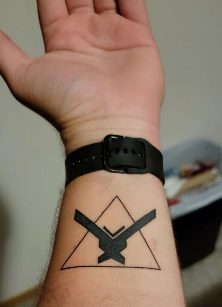 Geometric Emblem in Triangle Frame Tattoo Design