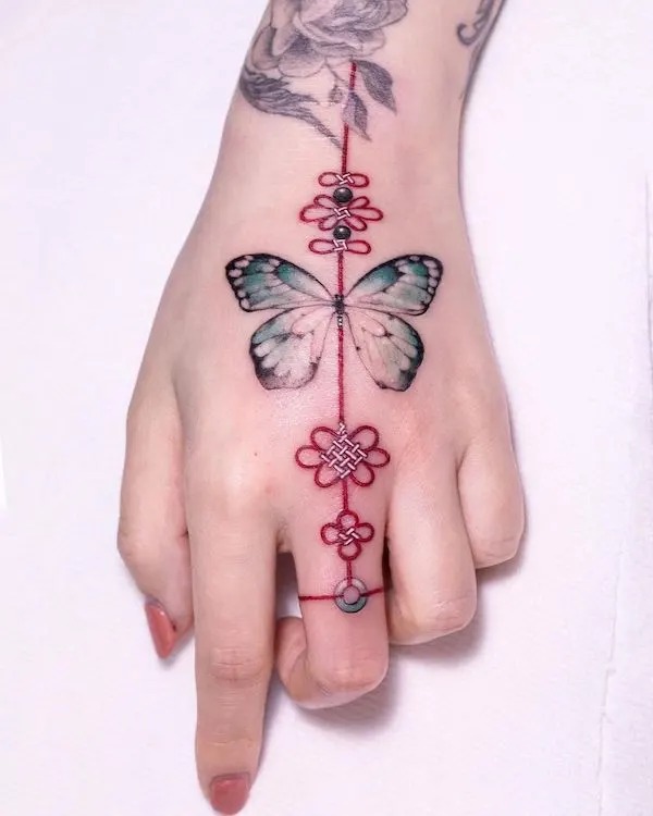 Butterfly and Knot Hand Tattoo with Vibrant Details Tattoo Design