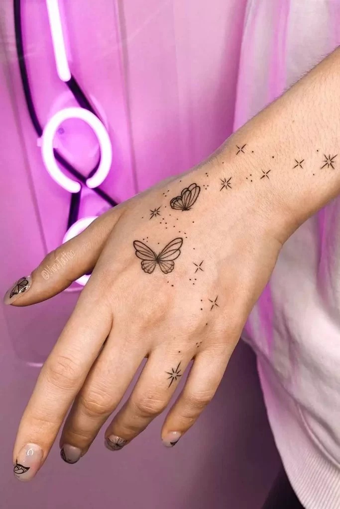 Butterfly and Stars Hand Tattoo with Minimalist Elegance Tattoo Design