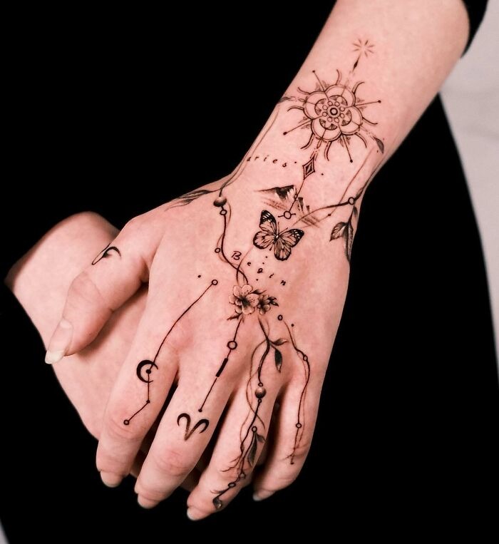 Celestial and Botanical Hand Tattoo with Butterflies Tattoo Design