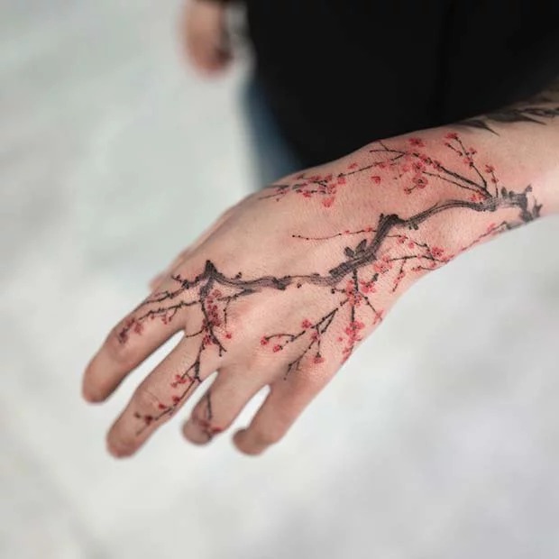 Cherry Blossom Hand Tattoo with Delicate Branches Tattoo Design