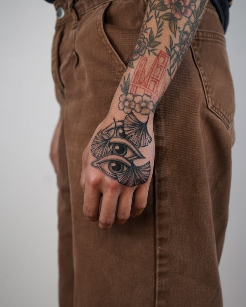 Eyes and Ginkgo Hand Tattoo Design Tattoo Design