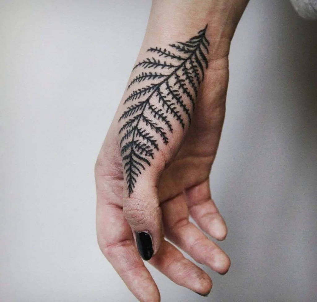 Fern Leaf Hand Tattoo with Bold Blackwork Tattoo Design