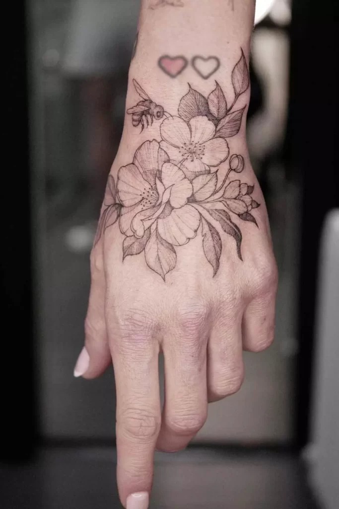 Floral and Bee Hand Tattoo with Delicate Details Tattoo Design