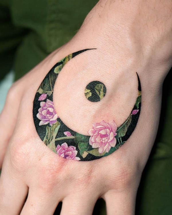 Floral Moon Hand Tattoo with Vibrant Design Tattoo Design